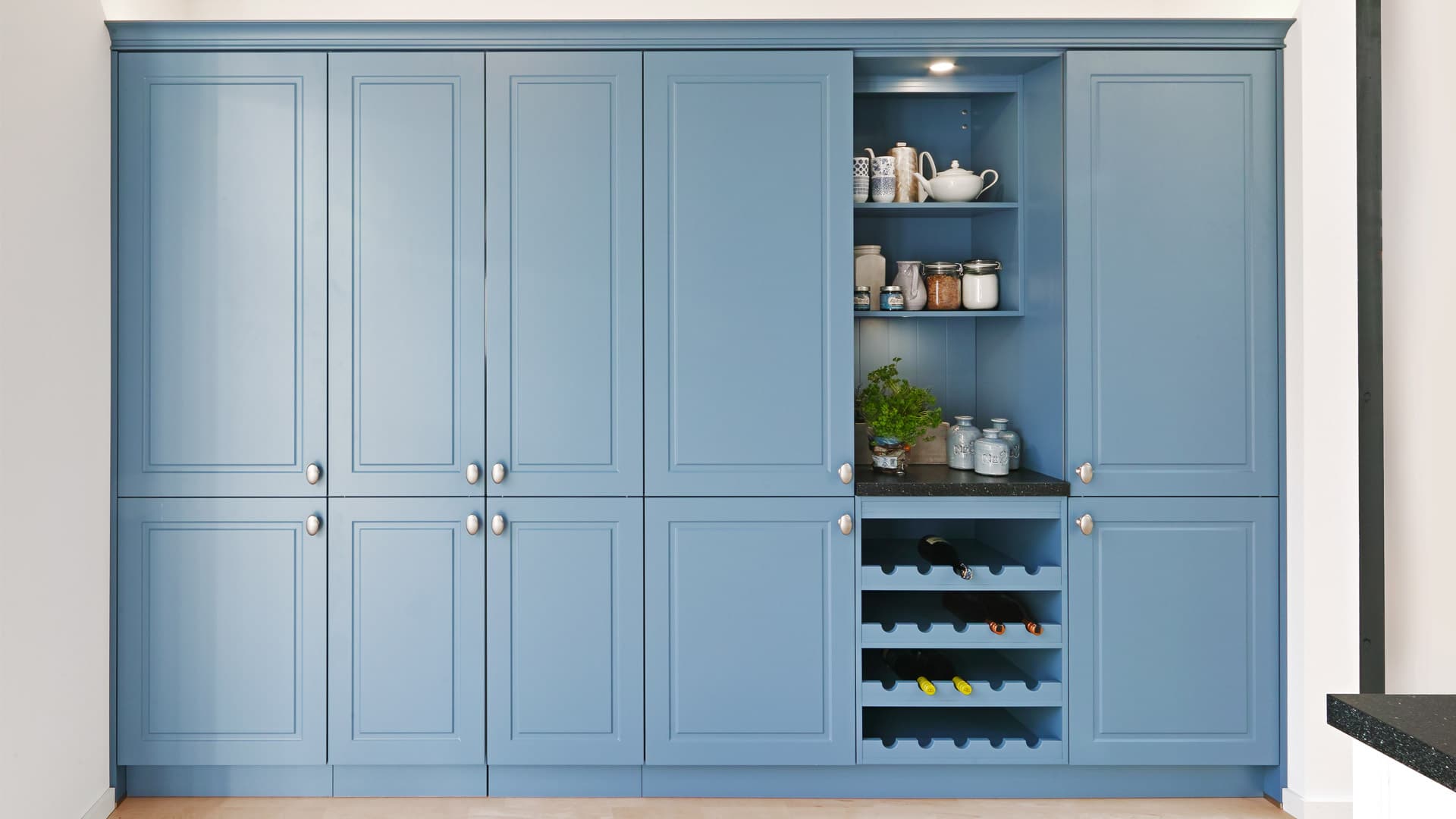 Blue kitchen floor-to-ceiling cupboards