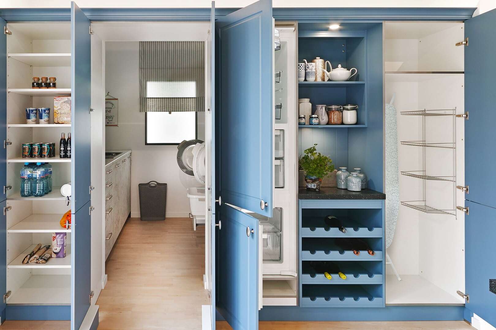 Blue kitchen floor-to-ceiling cupboards featured in a kitchen and pantry area