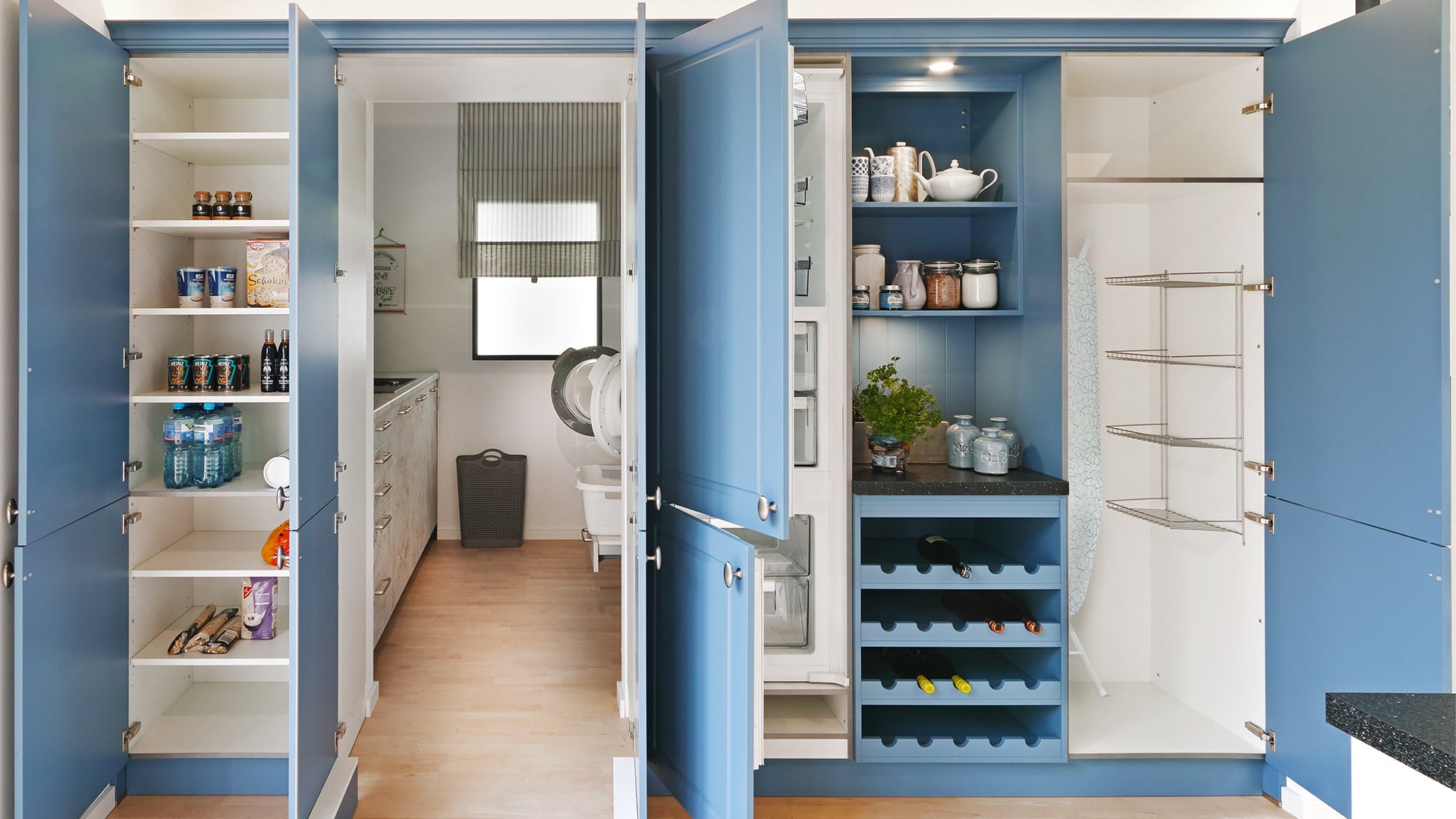 Blue kitchen floor-to-ceiling cupboards featured in a kitchen and pantry area