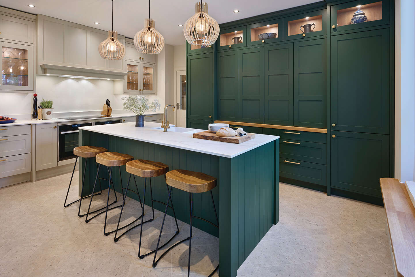 Green kitchen cupboards paired with white marble worktop featured in Callerton kitchen design