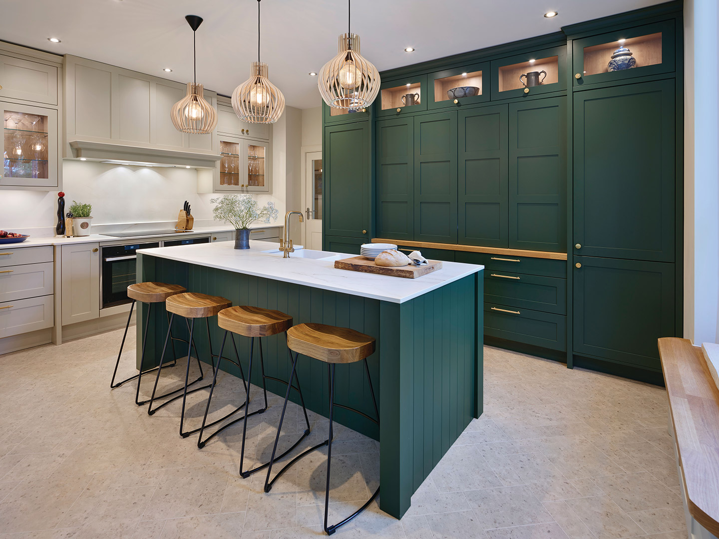 Green kitchen cupboards paired with white marble worktop featured in Callerton kitchen design